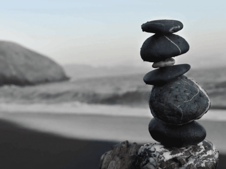 Stacked stones on a beach symbolizing balance and relaxation